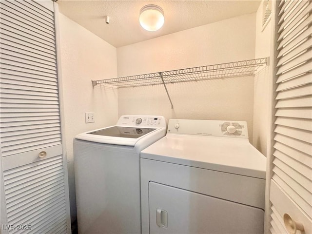 laundry room with washing machine and dryer