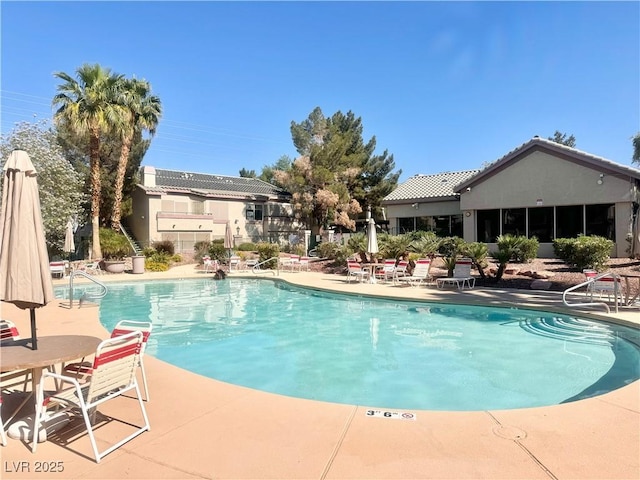 community pool featuring a patio area