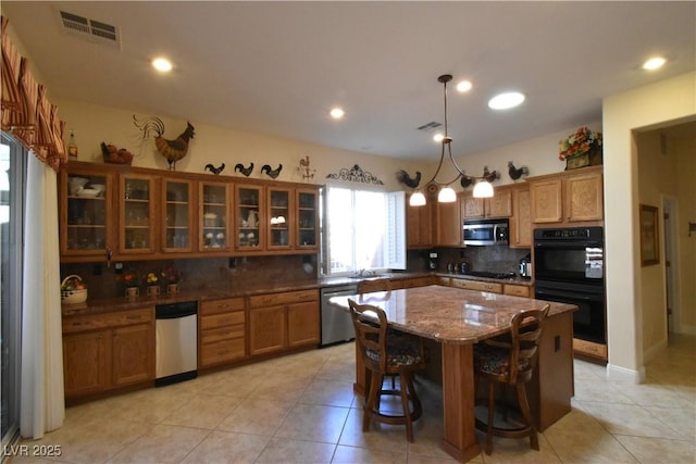 7325 Rustic Crest St, Las Vegas, NV 89149 - kitchen with stainless steel appliances, brown cabinetry, backsplash, light tile patterned floors, and recessed lighting