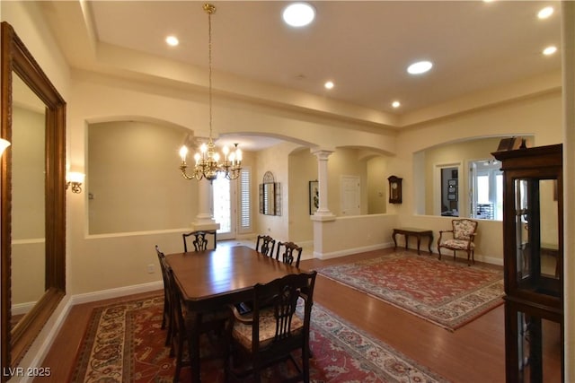 7325 Rustic Crest St, Las Vegas, NV 89149 - dining space featuring arched walkways, wood finished floors, a raised ceiling, a chandelier, and recessed lighting