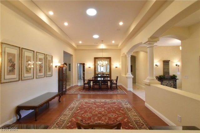 7325 Rustic Crest St, Las Vegas, NV 89149 - hall with ornate columns, arched walkways, wood finished floors, recessed lighting, and a chandelier