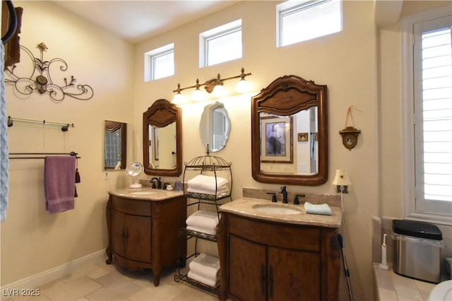 7325 Rustic Crest St, Las Vegas, NV 89149 - bathroom featuring two vanities, baseboards, and tile patterned floors