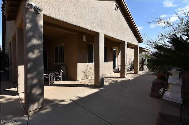 7325 Rustic Crest St, Las Vegas, NV 89149 - view of home's exterior featuring stucco siding and a patio