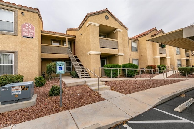 2300 E Silverado Ranch Blvd Unit 1070, Las Vegas, NV 89183 - view of building exterior with stairway and uncovered parking