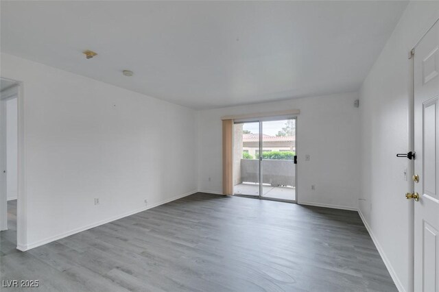 2300 E Silverado Ranch Blvd Unit 1070, Las Vegas, NV 89183 - empty room with wood finished floors and baseboards