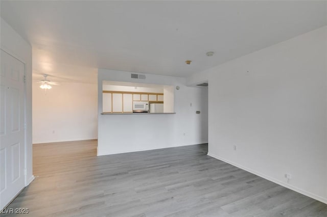 2300 E Silverado Ranch Blvd Unit 1070, Las Vegas, NV 89183 - unfurnished living room with wood finished floors, a ceiling fan, and baseboards