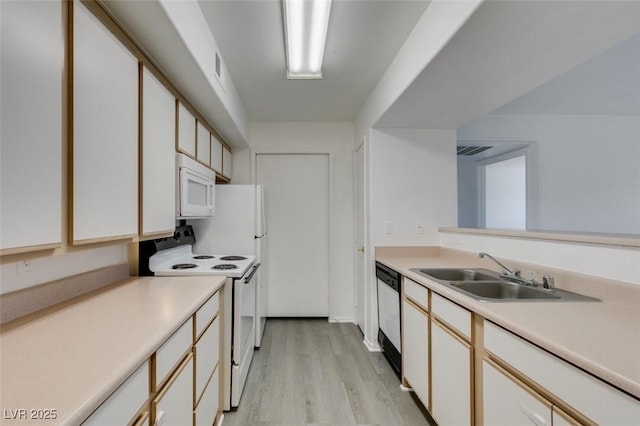 2300 E Silverado Ranch Blvd Unit 1070, Las Vegas, NV 89183 - kitchen with white appliances, a sink, light wood-type flooring, and light countertops