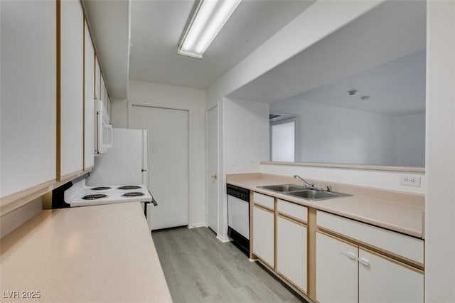 2300 E Silverado Ranch Blvd Unit 1070, Las Vegas, NV 89183 - kitchen featuring a sink, white appliances, light wood finished floors, light countertops, and white cabinets