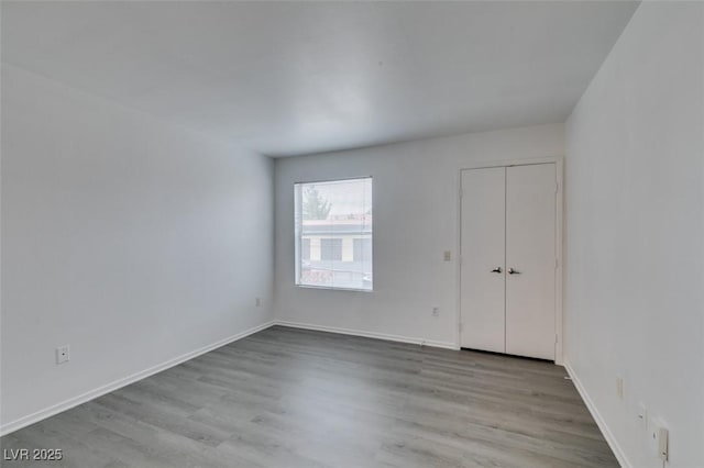 2300 E Silverado Ranch Blvd Unit 1070, Las Vegas, NV 89183 - unfurnished bedroom with wood finished floors and baseboards