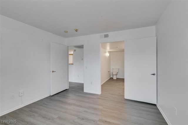 2300 E Silverado Ranch Blvd Unit 1070, Las Vegas, NV 89183 - unfurnished bedroom with wood finished floors and baseboards