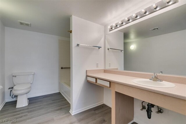 2300 E Silverado Ranch Blvd Unit 1070, Las Vegas, NV 89183 - full bath with toilet, wood finished floors, baseboards, and vanity