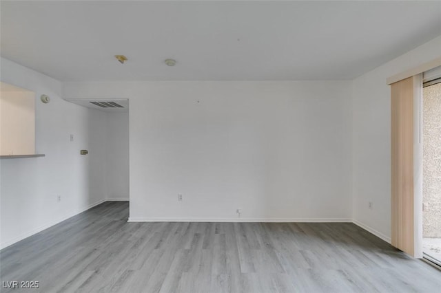 2300 E Silverado Ranch Blvd Unit 1070, Las Vegas, NV 89183 - spare room with wood finished floors, baseboards, and healthy amount of natural light