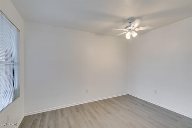 2300 E Silverado Ranch Blvd Unit 1070, Las Vegas, NV 89183 - unfurnished room with light wood-style flooring, a ceiling fan, plenty of natural light, and baseboards