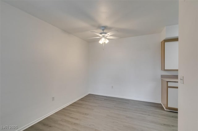 2300 E Silverado Ranch Blvd Unit 1070, Las Vegas, NV 89183 - unfurnished room with ceiling fan, light wood-style floors, and baseboards