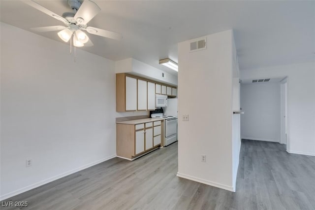 2300 E Silverado Ranch Blvd Unit 1070, Las Vegas, NV 89183 - kitchen featuring white appliances, a ceiling fan, light wood-style flooring, baseboards, and light countertops