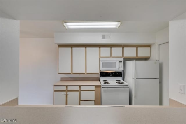 2300 E Silverado Ranch Blvd Unit 1070, Las Vegas, NV 89183 - kitchen featuring white appliances, light countertops, and white cabinets