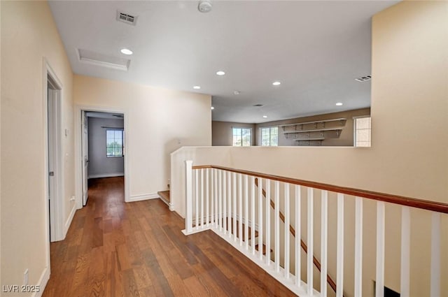 hall featuring an upstairs landing, attic access, wood finished floors, recessed lighting, and baseboards