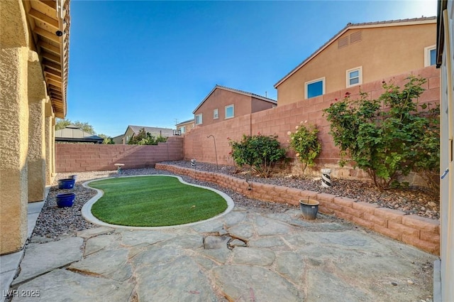 fenced backyard with a patio area