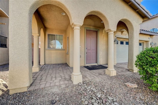 entrance to property featuring stucco siding