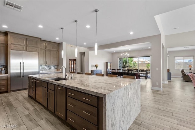 7477 Triple Knot Ct, Las Vegas, NV 89113 - kitchen featuring a sink, stainless steel built in refrigerator, a center island with sink, light wood-type flooring, and recessed lighting