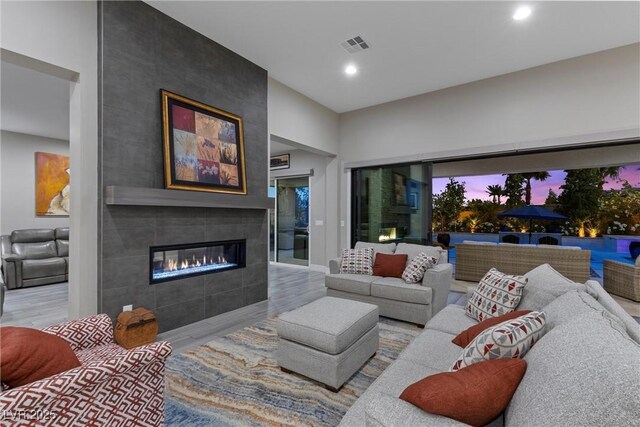 7477 Triple Knot Ct, Las Vegas, NV 89113 - living area with wood finished floors, a tile fireplace, and recessed lighting