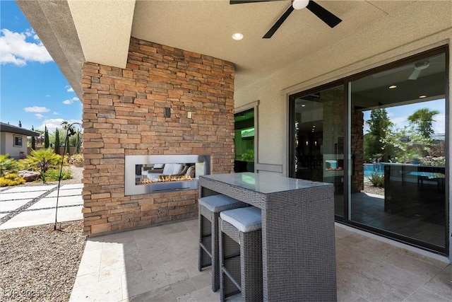 7477 Triple Knot Ct, Las Vegas, NV 89113 - view of patio with an outdoor stone fireplace and a ceiling fan