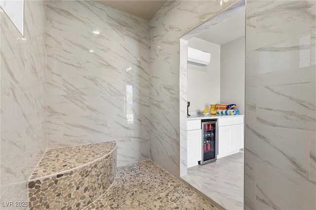 7477 Triple Knot Ct, Las Vegas, NV 89113 - bathroom featuring wine cooler, a wall unit AC, tiled shower, marble finish flooring, and tile walls