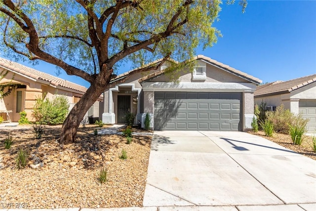 ranch-style house featuring driveway, a garage, stucco siding, and a tiled roof