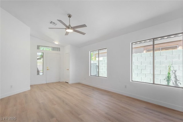 unfurnished room with a ceiling fan, light wood-style flooring, plenty of natural light, and lofted ceiling
