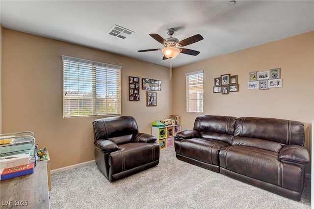 living area featuring a ceiling fan, carpet, and baseboards