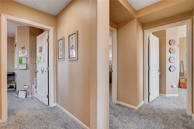 hall with carpet and baseboards