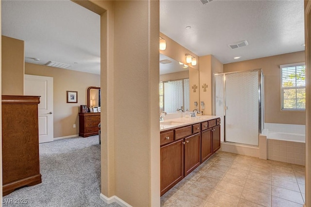 full bath with a shower stall, a bath, double vanity, and tile patterned floors