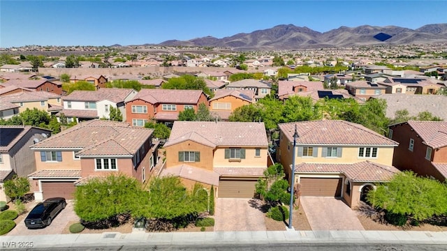 aerial view of residential area featuring a mountainous background