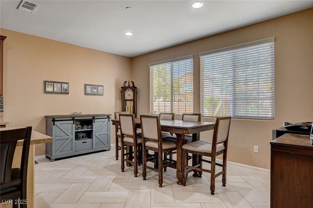 dining room with healthy amount of natural light, recessed lighting, and baseboards