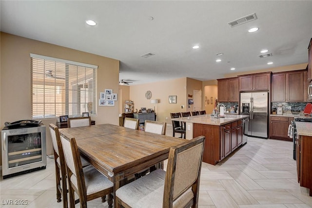 dining room with recessed lighting, beverage cooler, heating unit, and ceiling fan