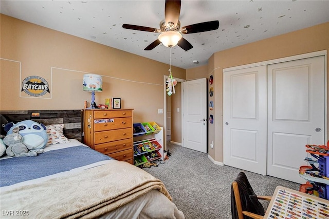 carpeted bedroom with a closet, a ceiling fan, and baseboards