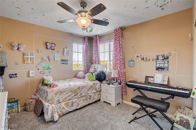 carpeted bedroom with baseboards and a ceiling fan