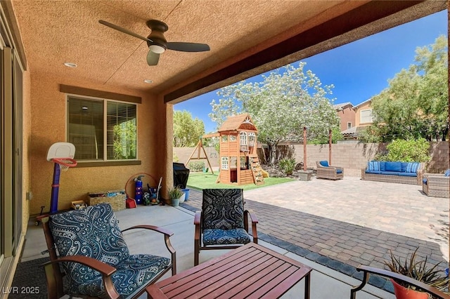 view of patio with a playground, outdoor lounge area, fence, ceiling fan, and outdoor dining area