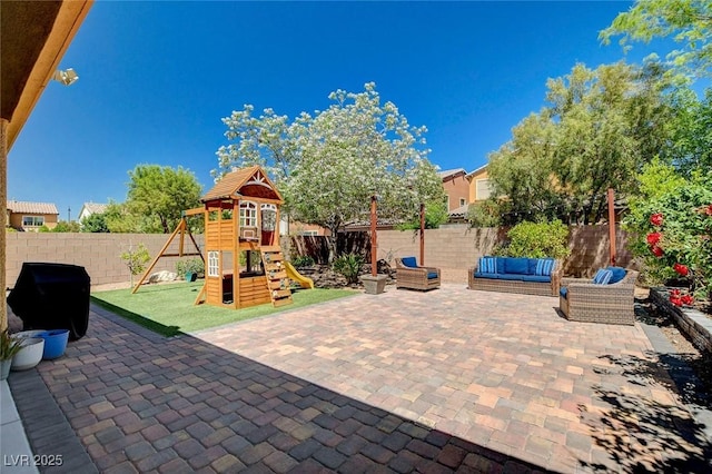 view of patio featuring a fenced backyard, a playground, and an outdoor living space