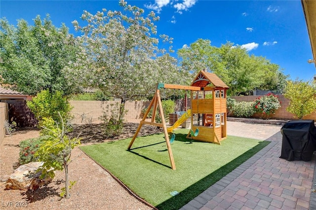 view of playground featuring a patio area