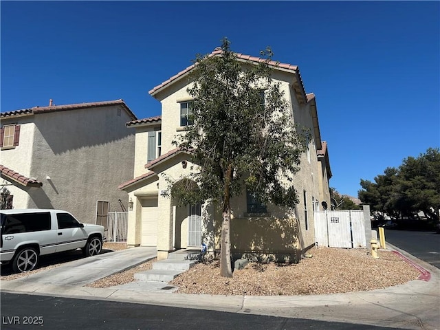 1310 Golden Apple St, Las Vegas, NV 89142 - view of front of property with stucco siding, a garage, a tiled roof, and driveway