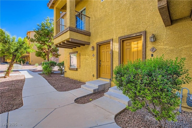 5915 Nuevo Leon St Unit 8, North Las Vegas, NV 89031 - property entrance featuring stucco siding and a balcony