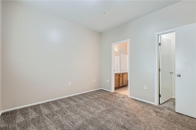 5915 Nuevo Leon St Unit 8, North Las Vegas, NV 89031 - unfurnished bedroom with light colored carpet, a spacious closet, and connected bathroom