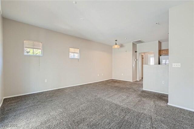 5915 Nuevo Leon St Unit 8, North Las Vegas, NV 89031 - carpeted spare room featuring baseboards