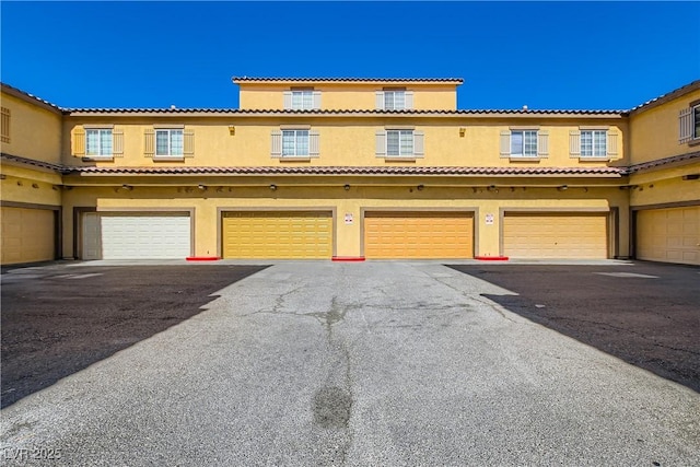 5915 Nuevo Leon St Unit 8, North Las Vegas, NV 89031 - townhome / multi-family property featuring stucco siding, an attached garage, and driveway