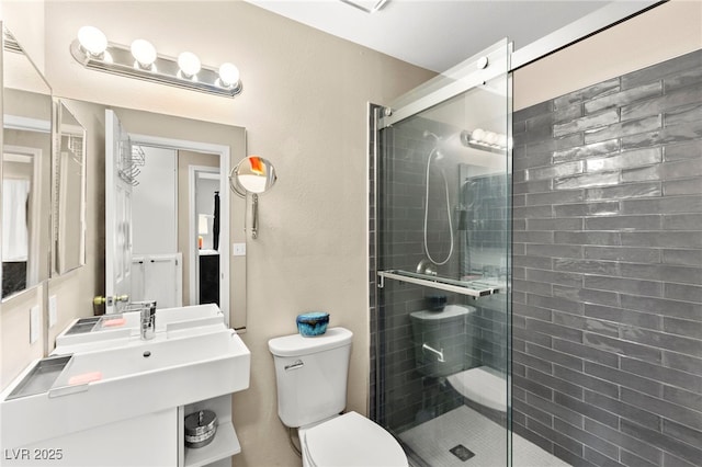 bathroom with a shower stall and toilet