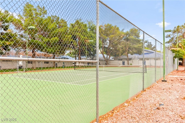 view of tennis court with fence