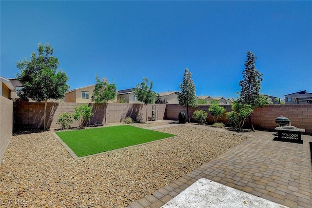 fenced backyard with a patio