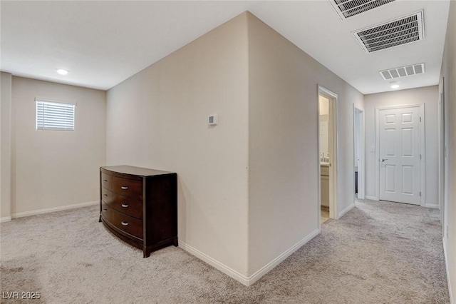 hallway with light carpet and baseboards