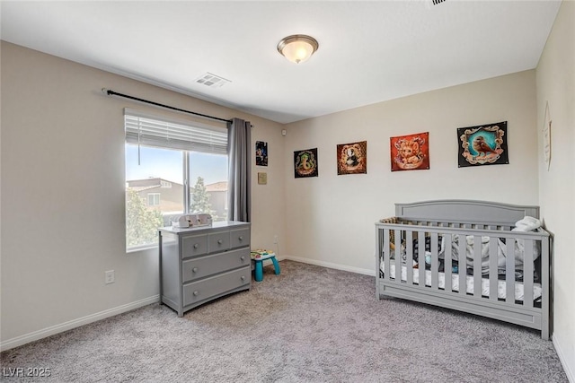carpeted bedroom with baseboards and a nursery area